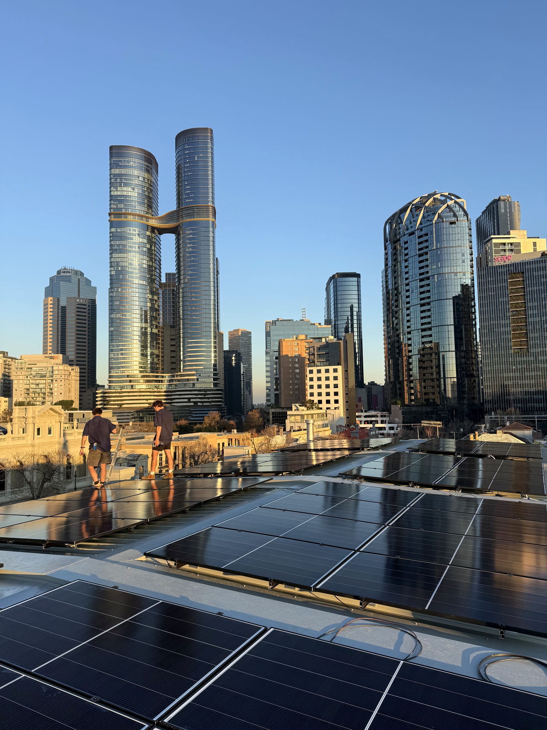 Solar panels installed by Carlin Co Electrical with Melbourne CBD skyline