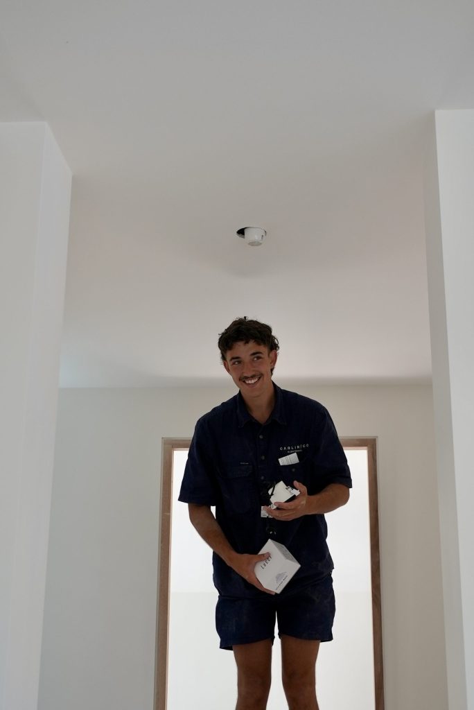 Carlin Co electrician installing smoke detector in Melbourne home