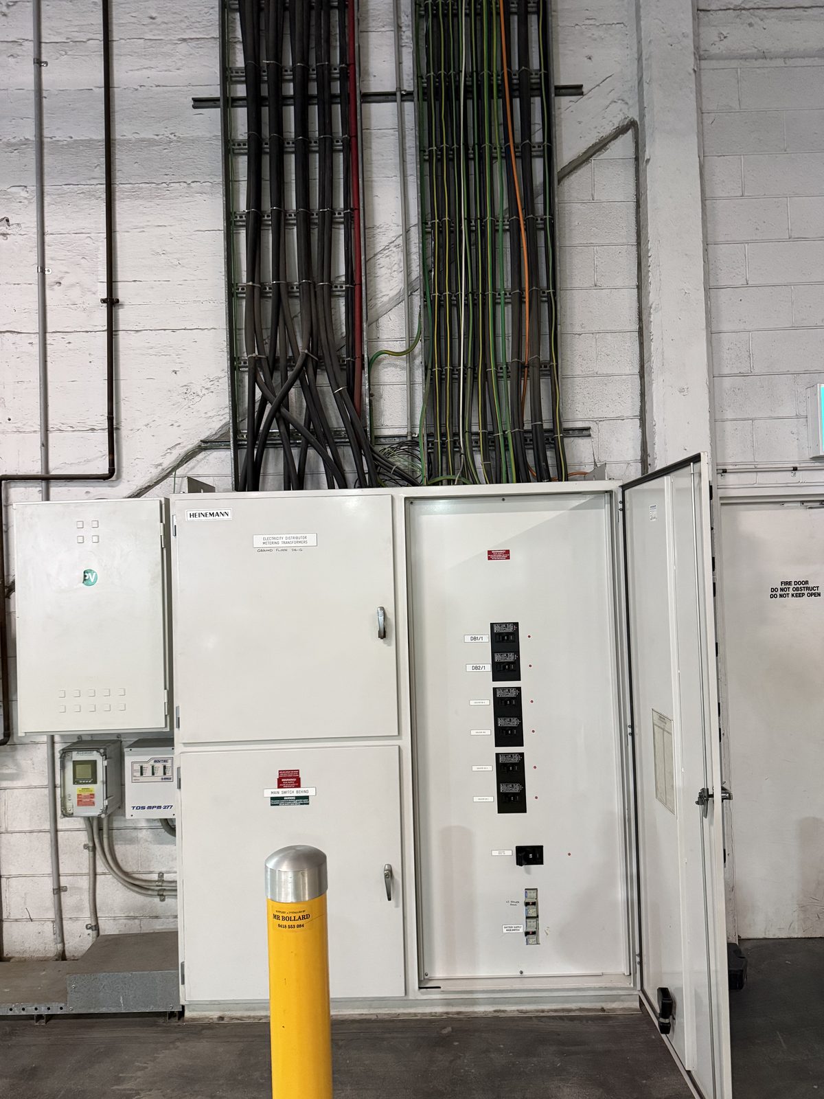 Commercial switchboard room with distribution boards and cable runs by Carlin Co Electrical Melbourne