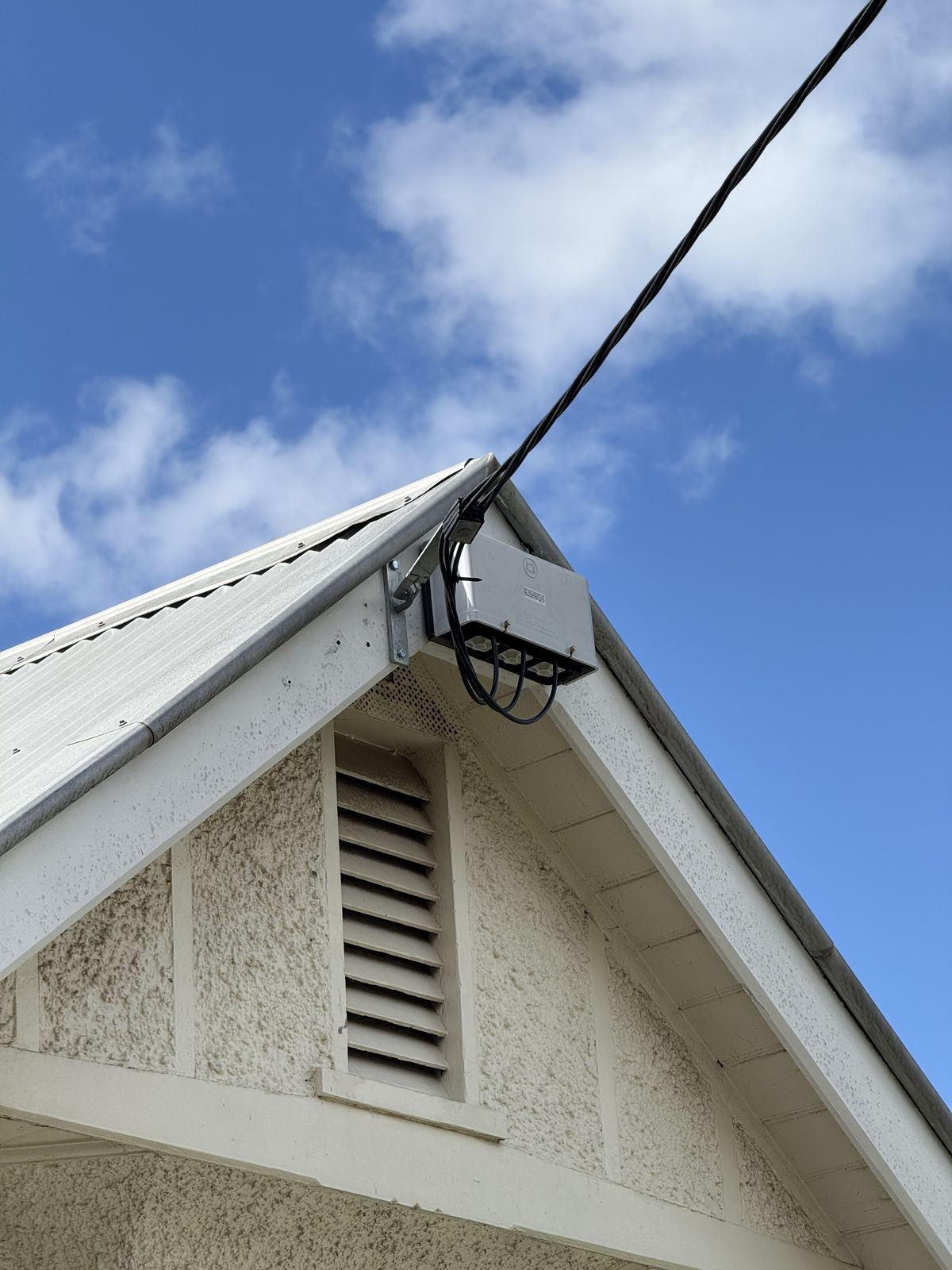 Overhead service line connection to house - mains point of attachment by Carlin Co Electrical