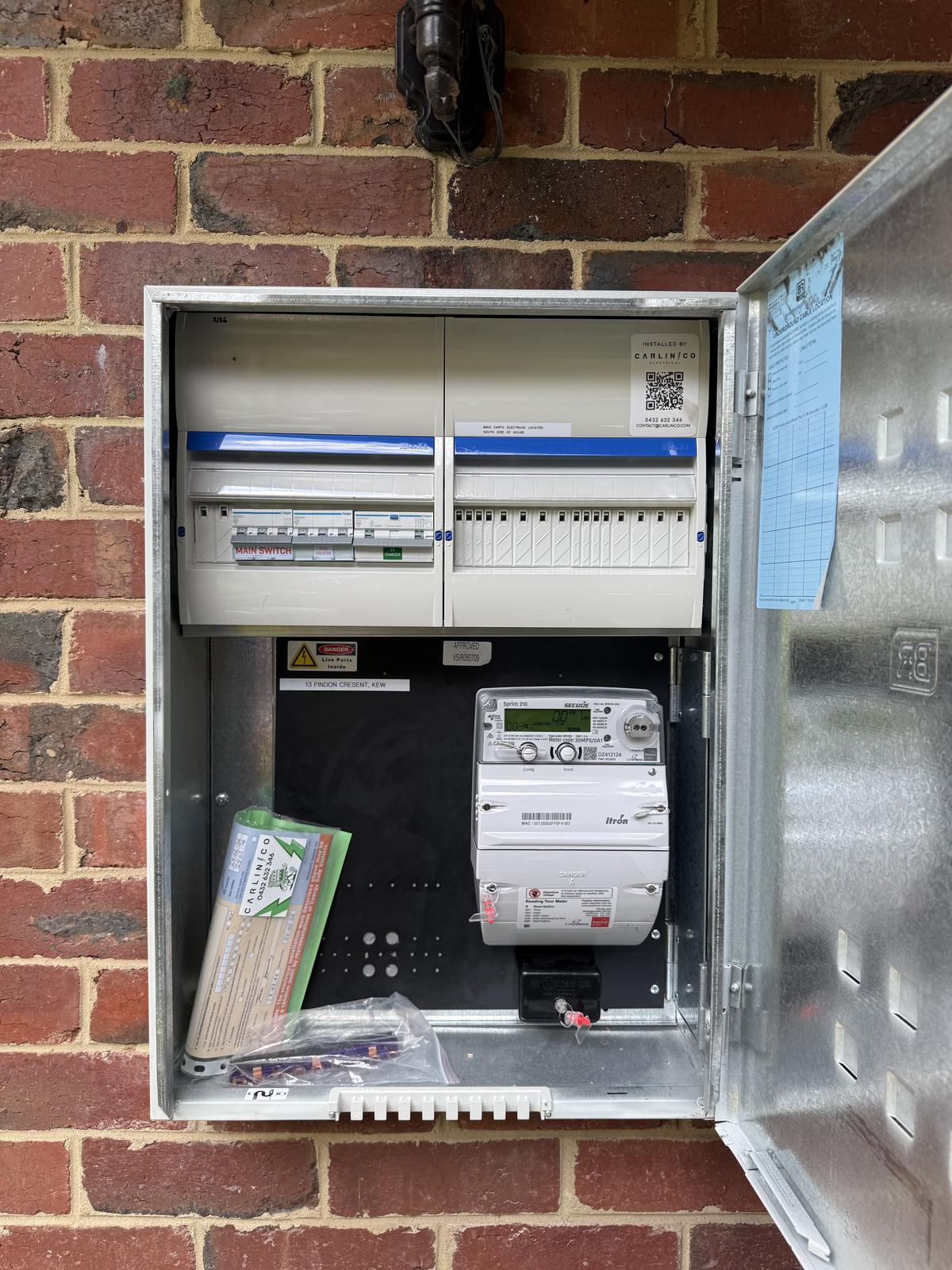 Completed three-phase meter box with dual switchboards by Carlin Co Electrical