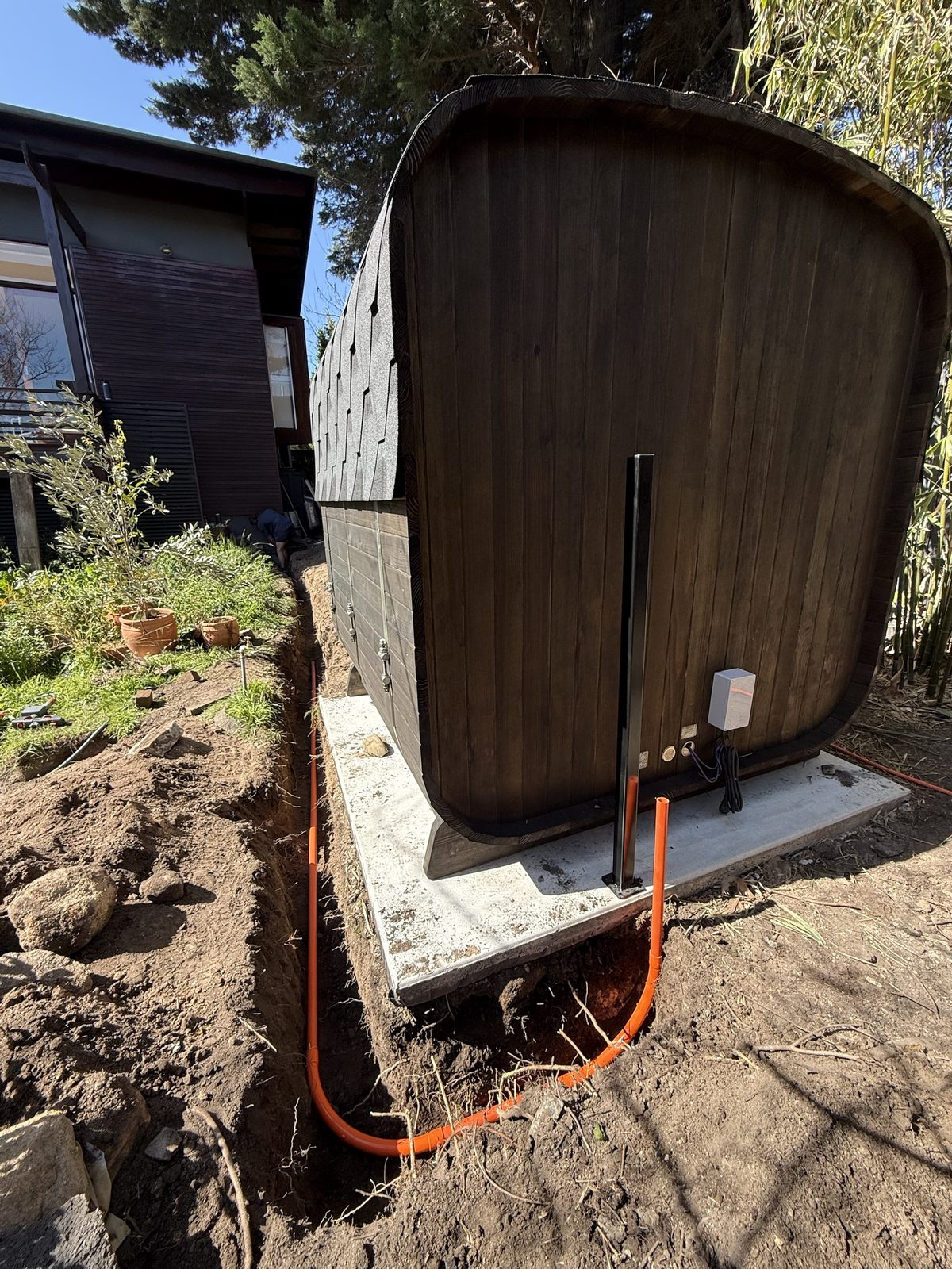 Completed underground three-phase conduit and electrical connection to barrel sauna on concrete pad Kew Melbourne